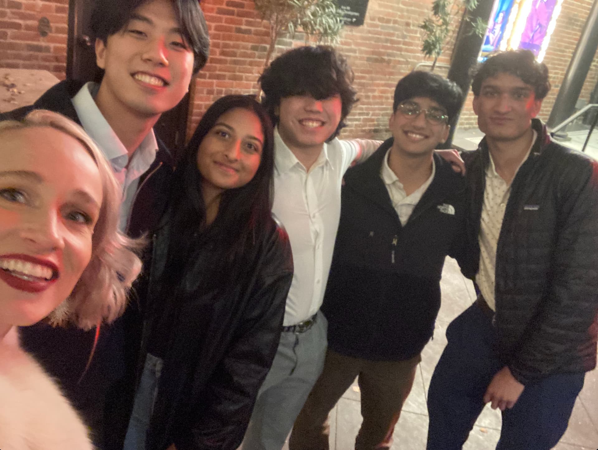 Cobalt members taking a group selfie outside at night