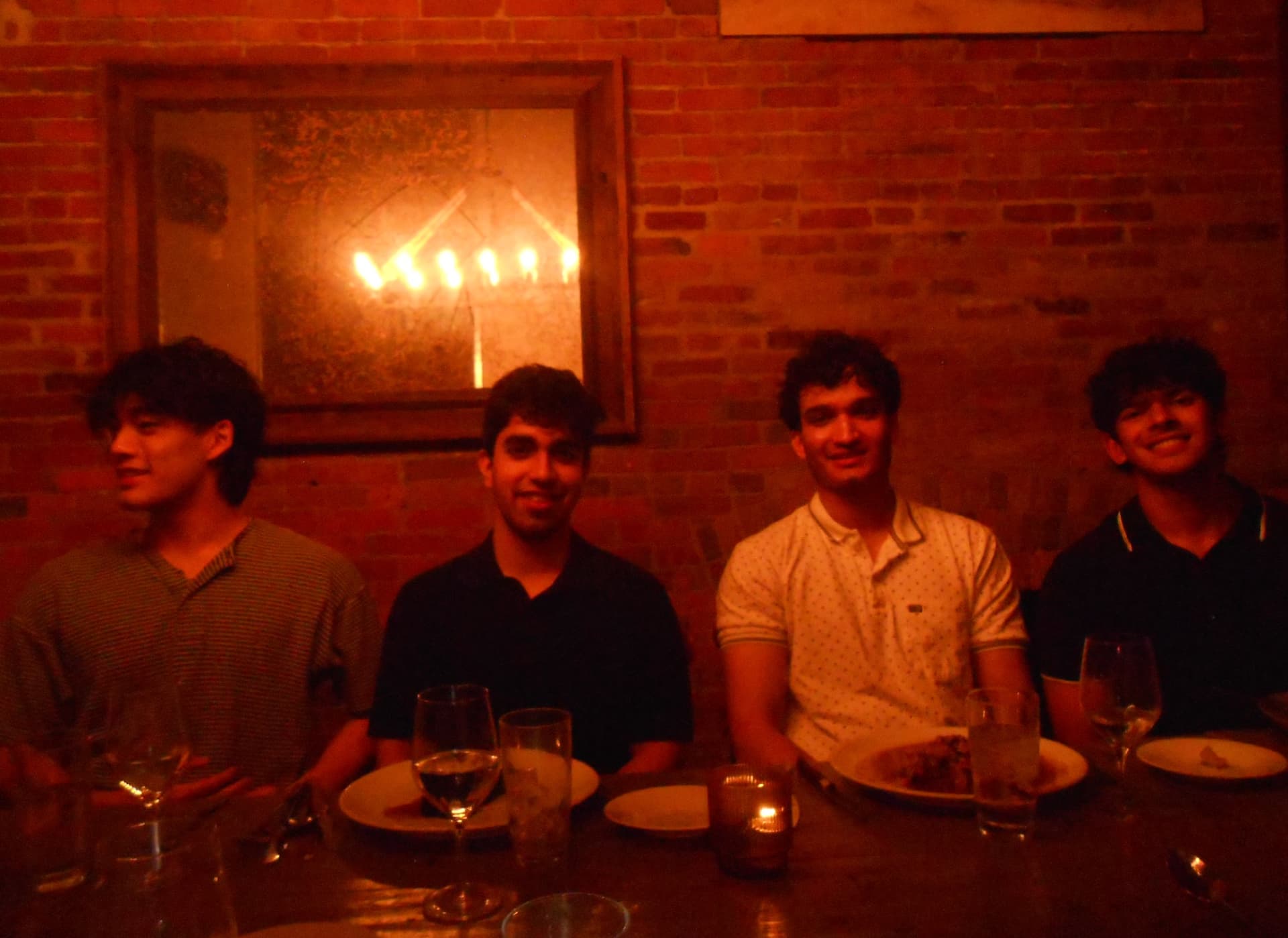 Four Cobalt members at a candlelit dinner table