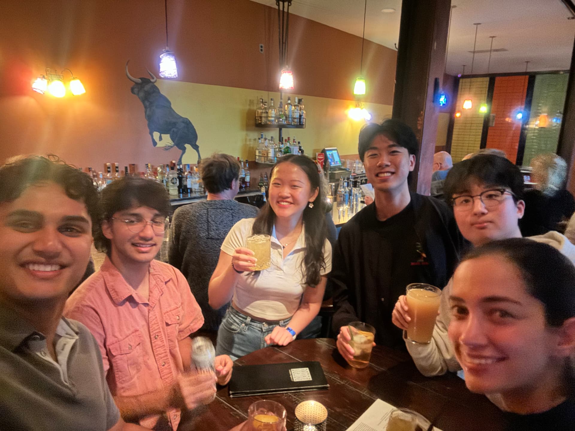 Cobalt members raising drinks together at a restaurant